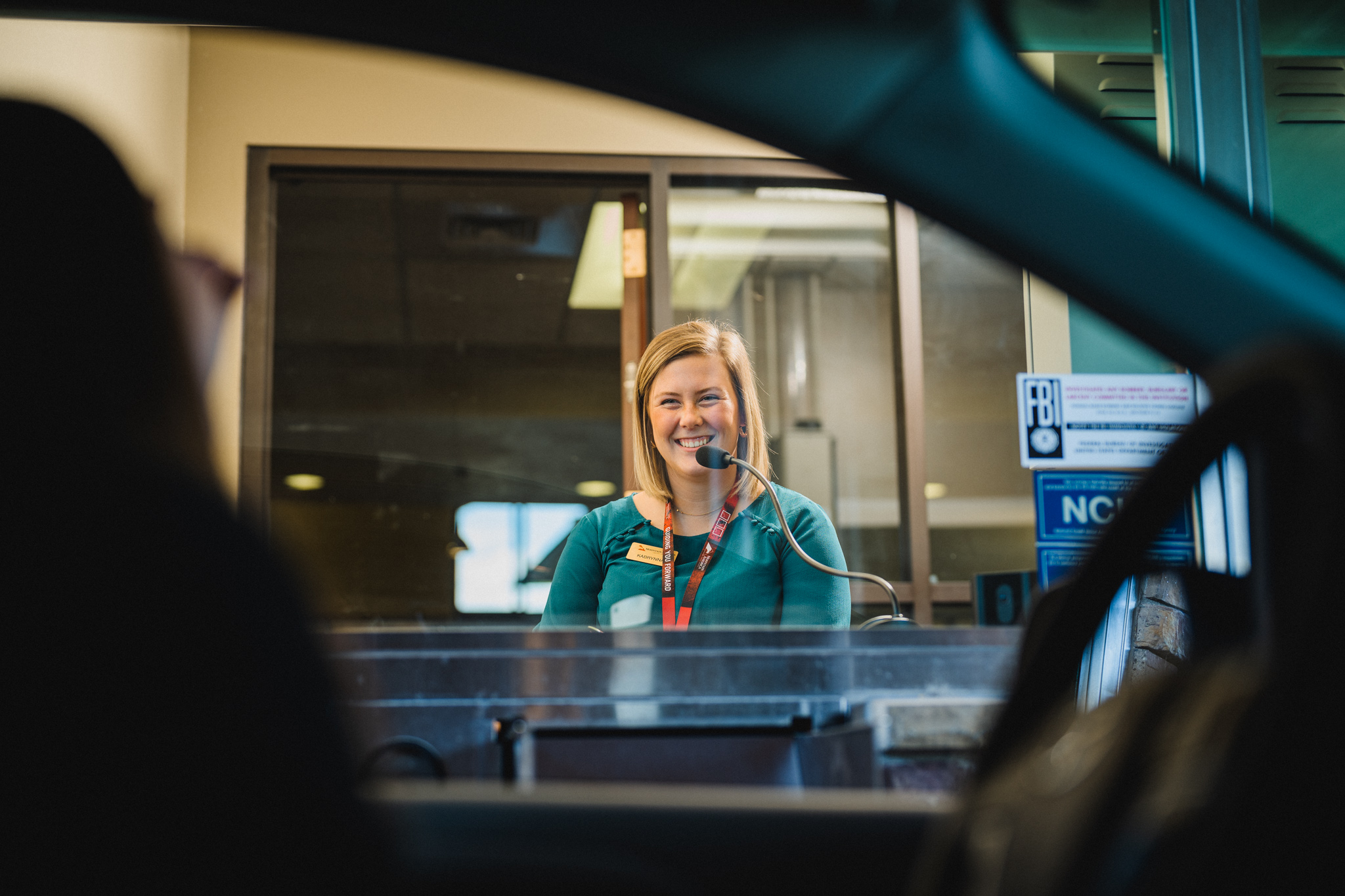 a person smiling at a desk