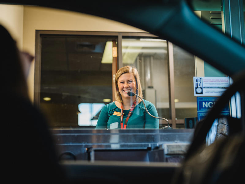 a person smiling at a desk