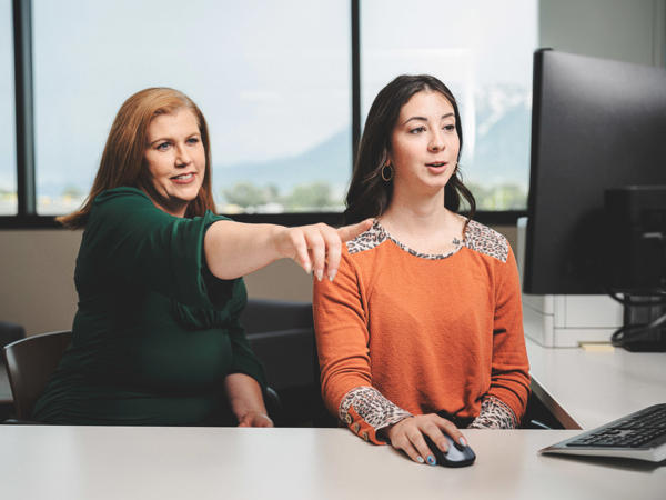 a person pointing at a computer screen