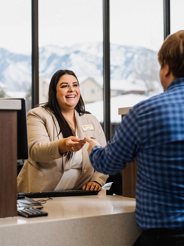 a person shaking hands with a person at a desk