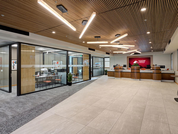 a large office lobby with a large glass wall and a desk