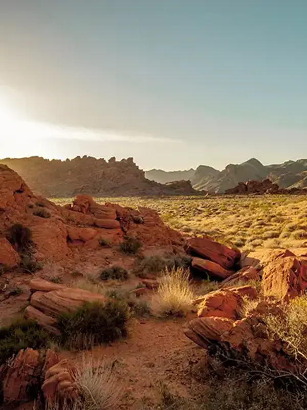a rocky landscape with a sun shining through