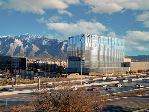a large building with a mountain in the background