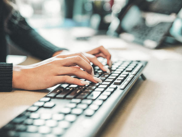 a person typing on a keyboard
